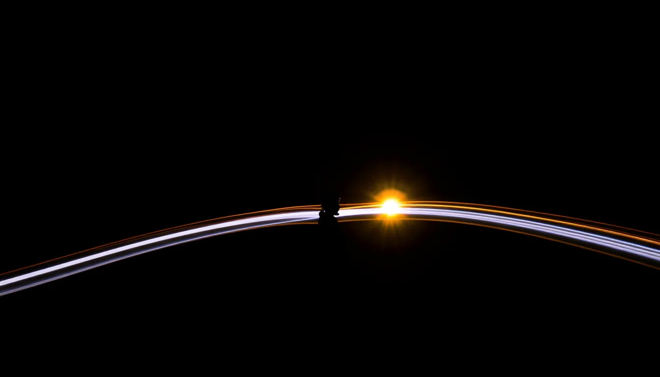 Two long-exposure light trails converge into a single bright point in a dark room, silhouette watching from the side